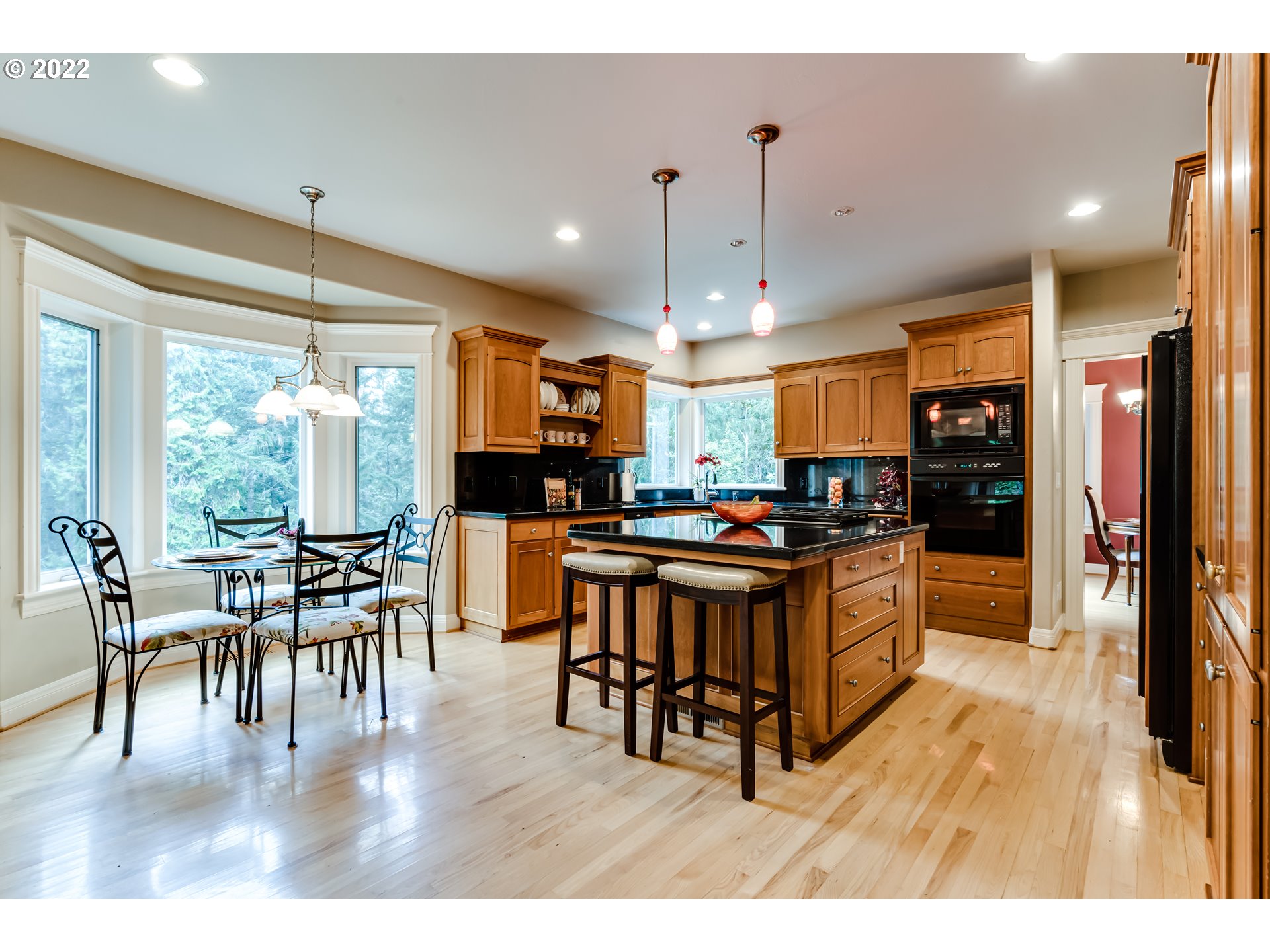 85281 Silver Crest Drive Eugene, OR 97405 - Photo 13 of 32 a open kitchen with stainless steel appliances granite countertop a stove a refrigerator a dining table and chairs with wooden floor