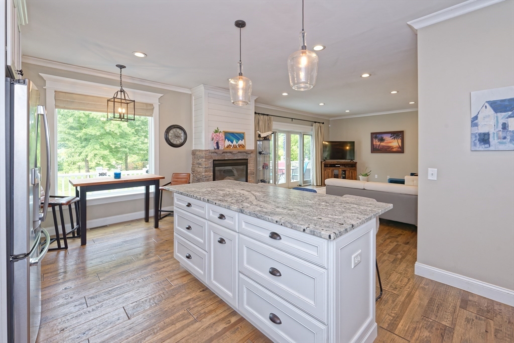 146 7 Bridge Road Lancaster, MA 01523 - Photo 13 of 42 a kitchen with kitchen island granite countertop a stove and a wooden floors