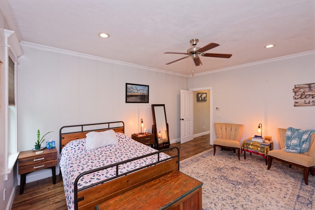 146 7 Bridge Road Lancaster, MA 01523 - Photo 16 of 42 a bedroom with a bed and a chandelier