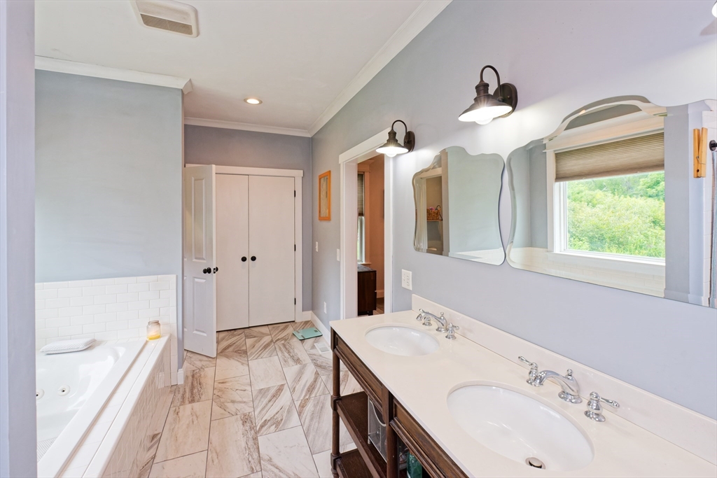 146 7 Bridge Road Lancaster, MA 01523 - Photo 19 of 42 a bathroom with a tub sink and mirror