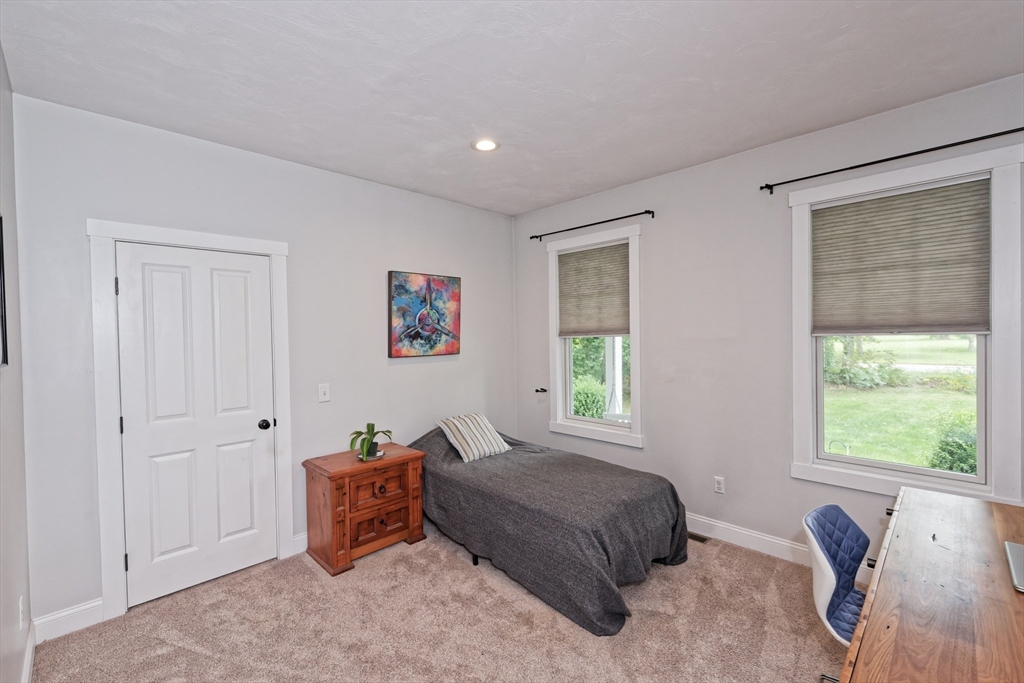 146 7 Bridge Road Lancaster, MA 01523 - Photo 23 of 42 a spacious bedroom with a bed and a window