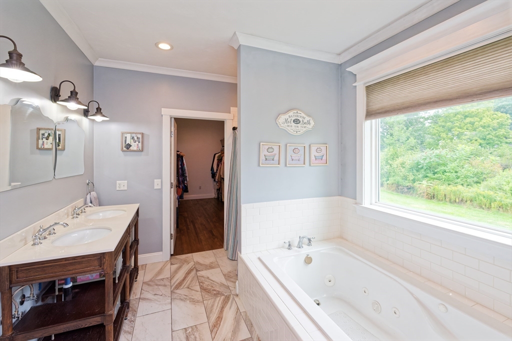 146 7 Bridge Road Lancaster, MA 01523 - Photo 25 of 42 a en suite spacious bathroom with a tub double vanity sink and a mirror