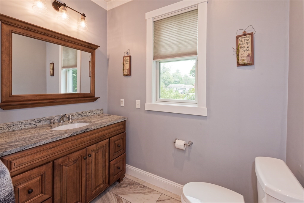 146 7 Bridge Road Lancaster, MA 01523 - Photo 26 of 42 a bathroom with a toilet a sink and mirror