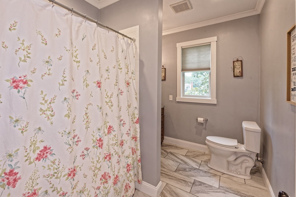 146 7 Bridge Road Lancaster, MA 01523 - Photo 27 of 42 a bathroom with a toilet and a shower curtain