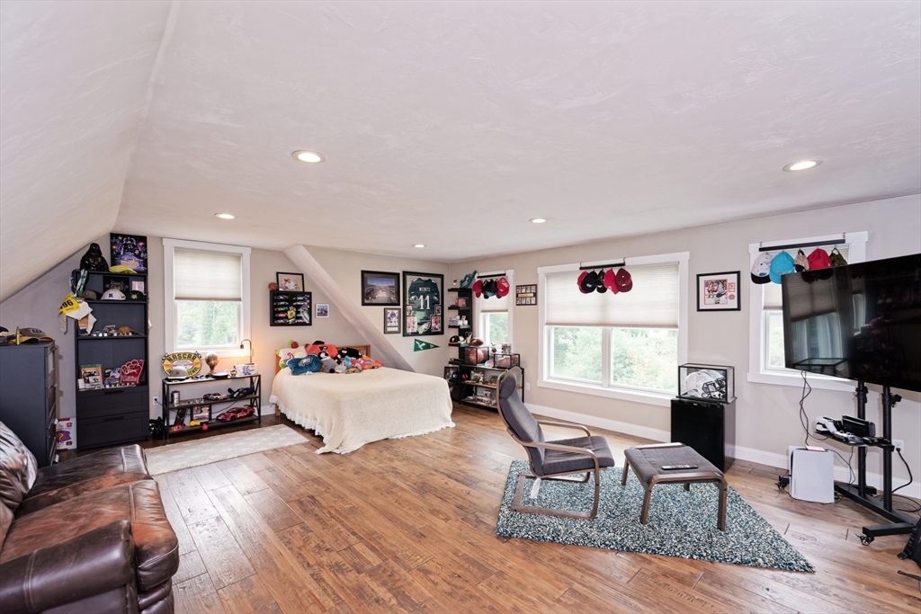 146 7 Bridge Road Lancaster, MA 01523 - Photo 28 of 42 a living room with furniture a flat screen tv and a window