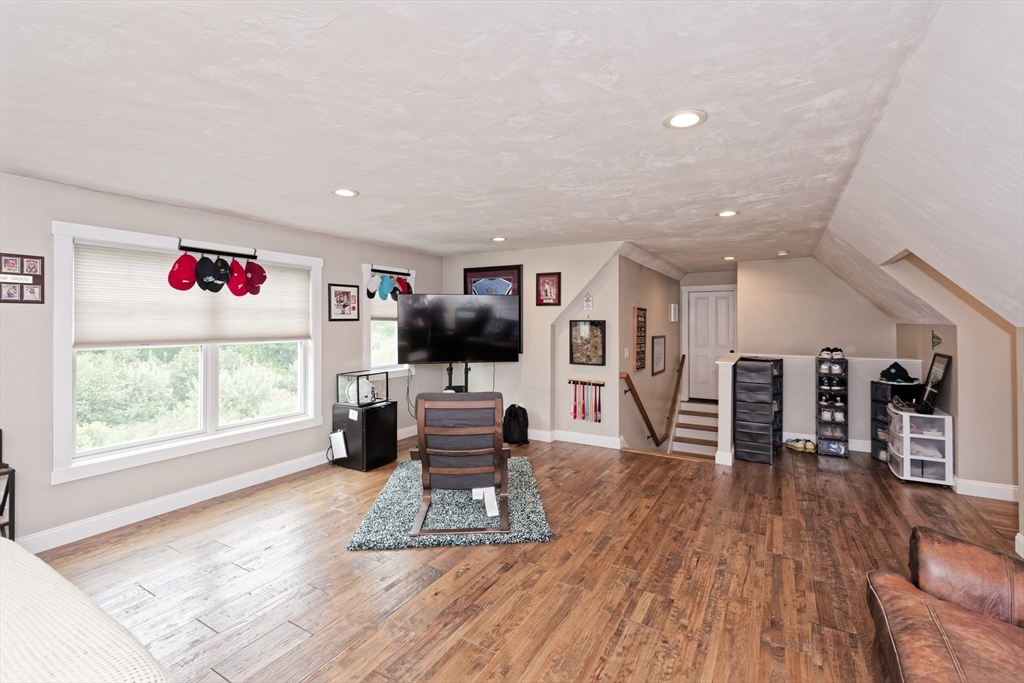 146 7 Bridge Road Lancaster, MA 01523 - Photo 30 of 42 a living room with furniture flat screen tv and wooden floor
