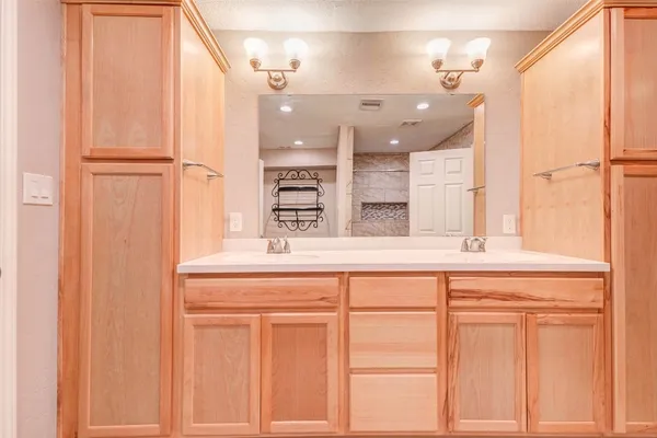a bathroom with a sink a vanity and a mirror