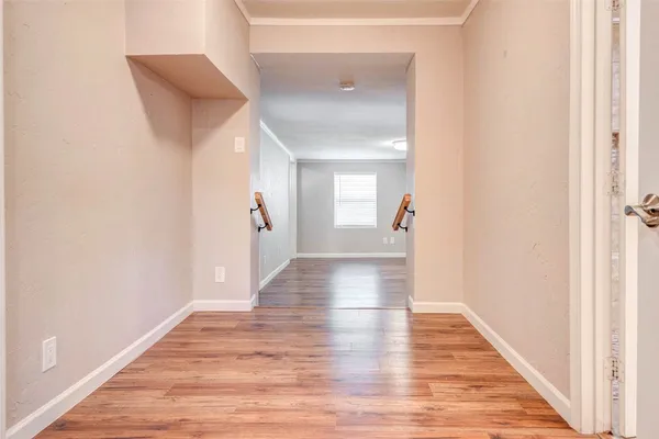 a view of a hallway with wooden floor
