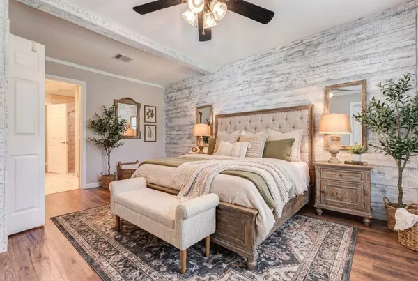 a spacious bedroom with a large bed and a chandelier