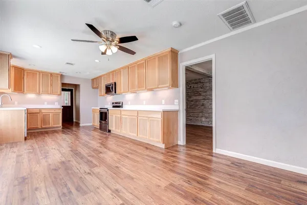 a kitchen with stainless steel appliances granite countertop a refrigerator and a stove top oven