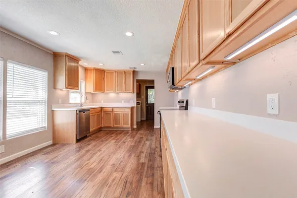 a view of a kitchen with a sink cabinets and a window