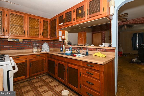 313 Sassafras Street Millville, NJ 08332 - Photo 17 of 25 a kitchen with a sink stove and cabinets