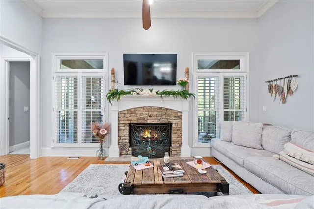 a living room with furniture a flat screen tv and a fireplace
