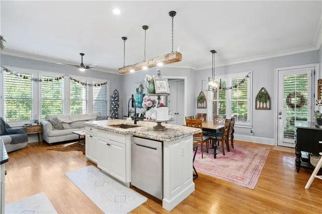 a kitchen with stainless steel appliances granite countertop a stove and white cabinets