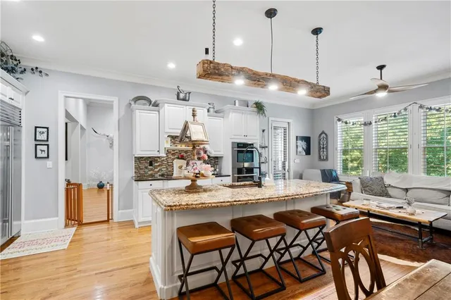 a large kitchen with a table and chairs