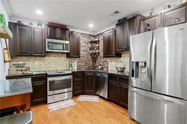 a kitchen with stainless steel appliances and refrigerator