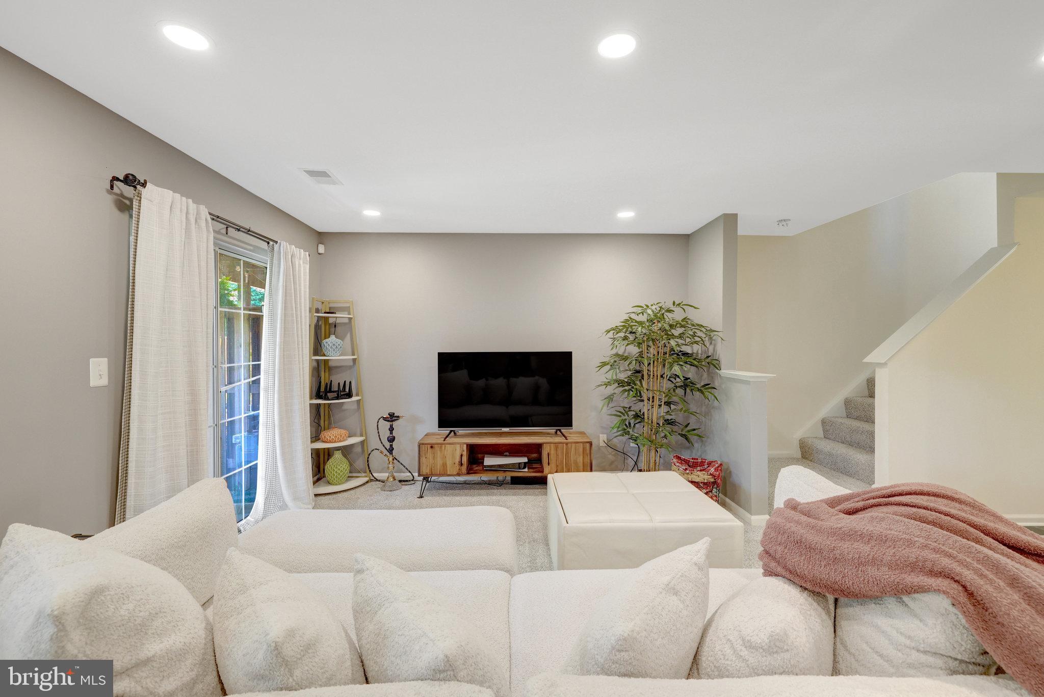 45509 Trail Run Terrace Sterling, VA 20164 - Photo 13 of 64 a living room with furniture and a flat screen tv