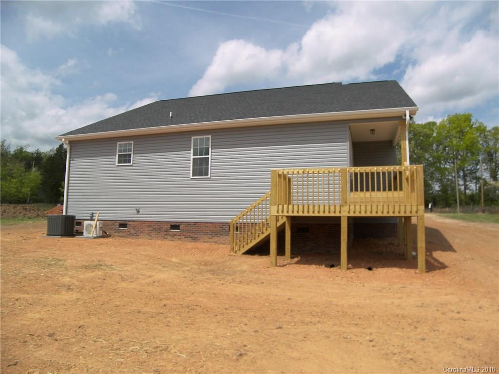 8275 Castor Road, Unit L3 Salisbury, NC 28146 - Photo 2 of 19 a front view of a house with a yard and garage