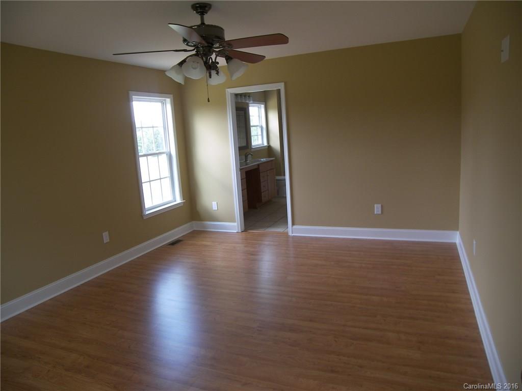 8275 Castor Road, Unit L3 Salisbury, NC 28146 - Photo 12 of 19 a view of an empty room with window and wooden floor