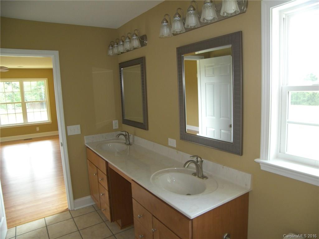 8275 Castor Road, Unit L3 Salisbury, NC 28146 - Photo 14 of 19 a bathroom with a sink and a mirror