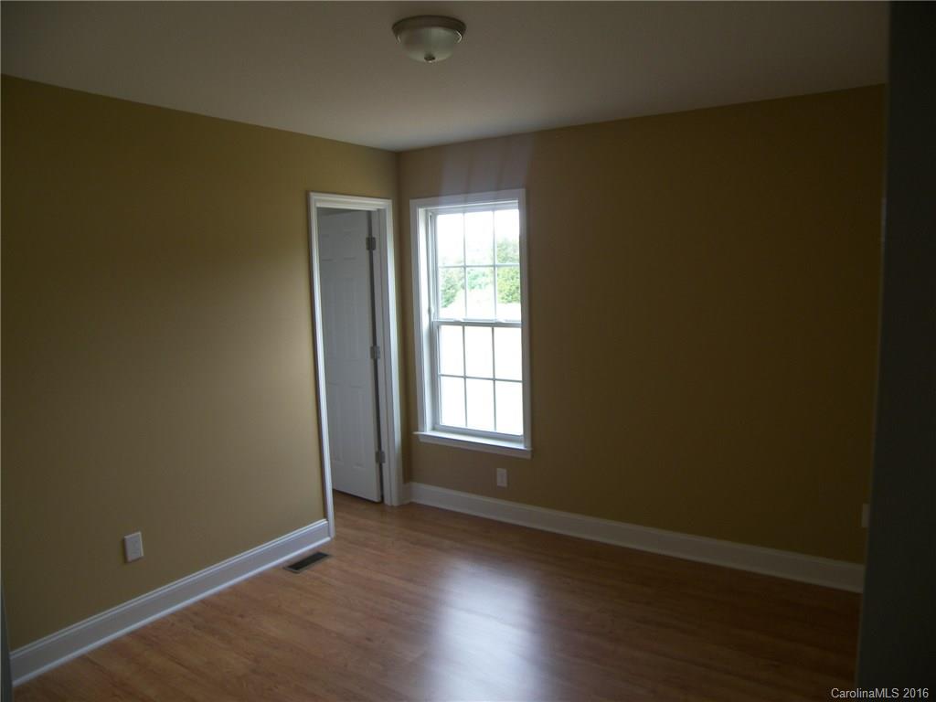 8275 Castor Road, Unit L3 Salisbury, NC 28146 - Photo 15 of 19 an empty room with wooden floor and windows