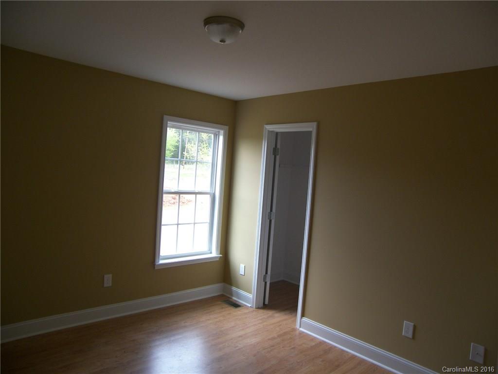 8275 Castor Road, Unit L3 Salisbury, NC 28146 - Photo 16 of 19 an empty room with wooden floor and windows