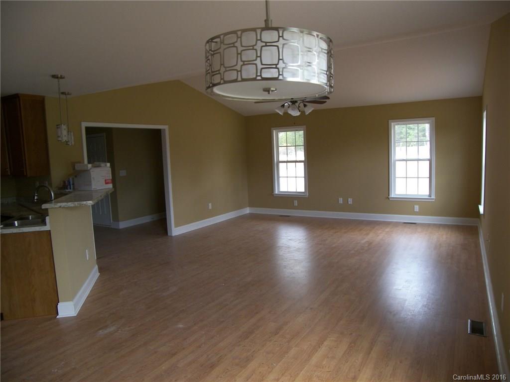 8275 Castor Road, Unit L3 Salisbury, NC 28146 - Photo 6 of 19 an empty room with wooden floor and windows