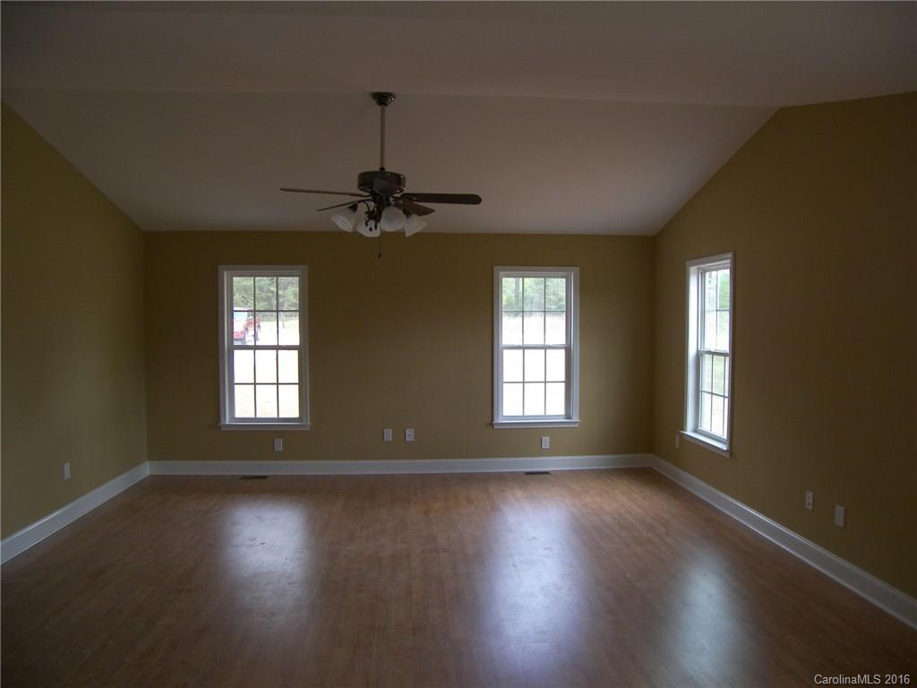 8275 Castor Road, Unit L3 Salisbury, NC 28146 - Photo 7 of 19 a view of an empty room with wooden floor and a window