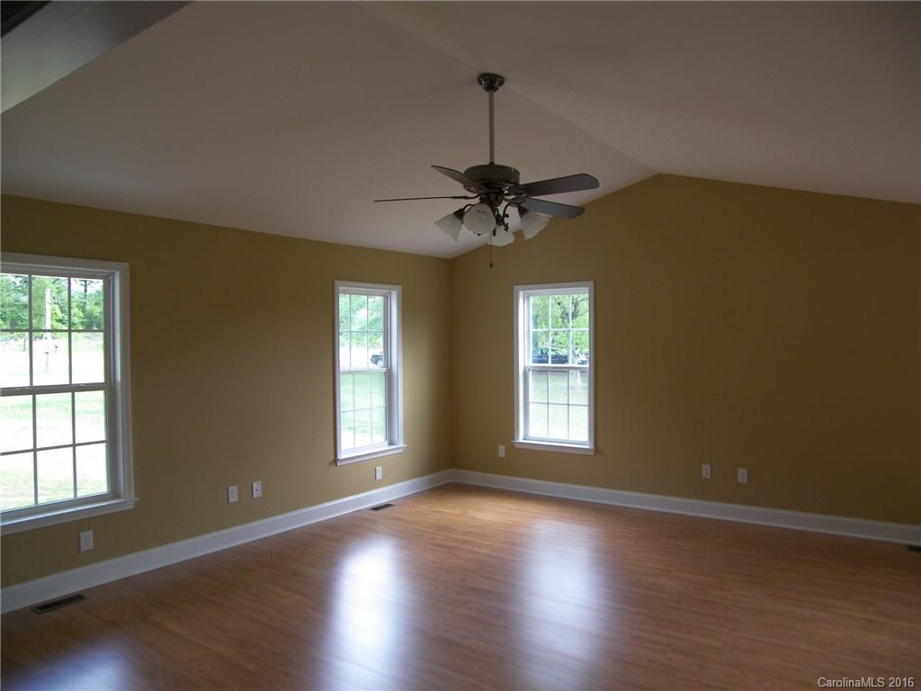8275 Castor Road, Unit L3 Salisbury, NC 28146 - Photo 8 of 19 a view of an empty room with a window and wooden floor