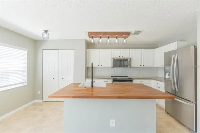 a kitchen with stainless steel appliances a refrigerator and a stove
