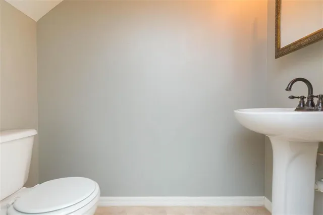 a white toilet sitting next to a white sink