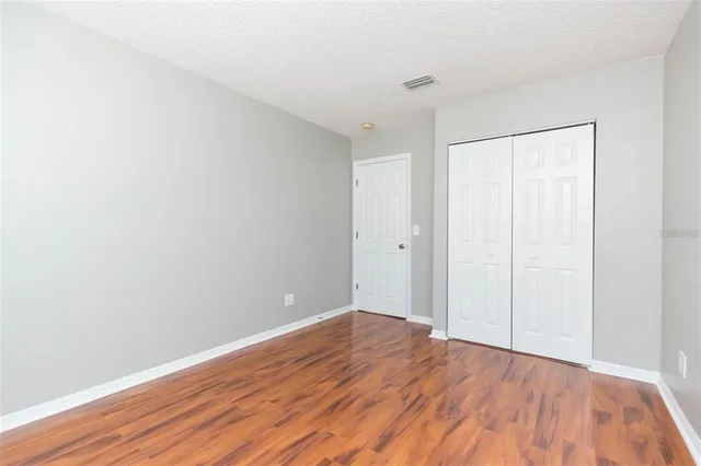 a view of room with wooden floor