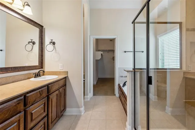 a en suite bathroom with a sink a mirror and a shower