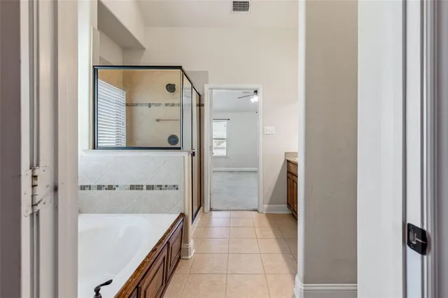 a bathroom with a bathtub and a shower