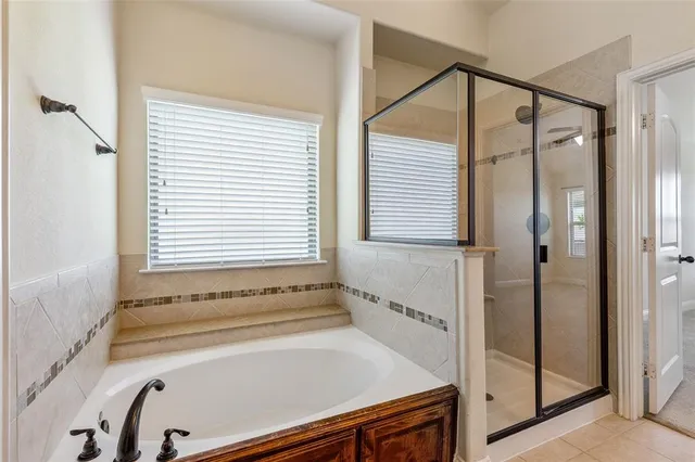 a bathroom with a bathtub and a shower