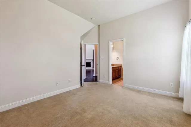 a view of an empty room and a window