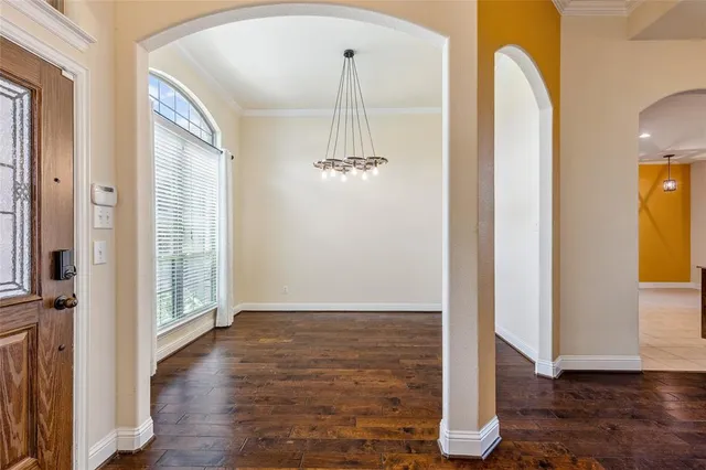a view of a room with wooden floor and front door