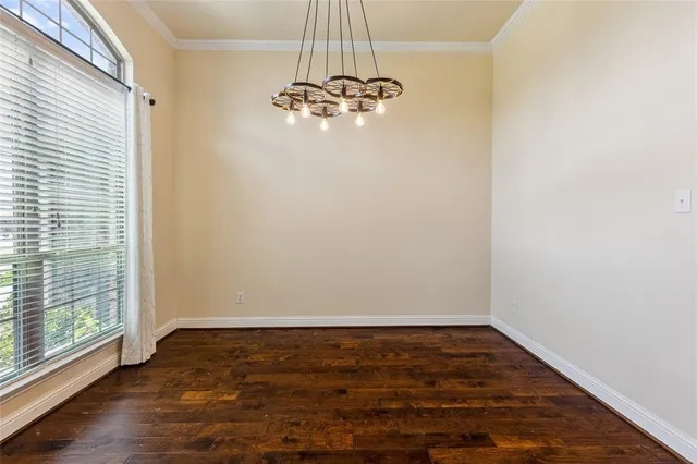 a view of a livingroom with wooden floor and a window