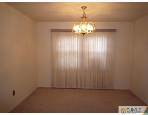 1921 Raspberry Court Edison, NJ 08817 - Photo 3 of 6 an empty room with a chandelier