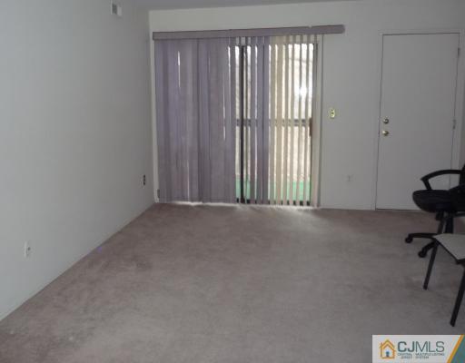 1921 Raspberry Court Edison, NJ 08817 - Photo 4 of 6 a view of an empty room and a window