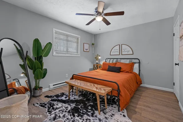 a bedroom with bed and a potted plant