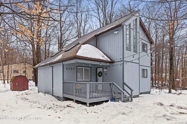 a view of a wooden house with a large trees