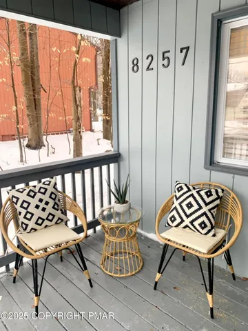 a view of a chairs and table in the balcony