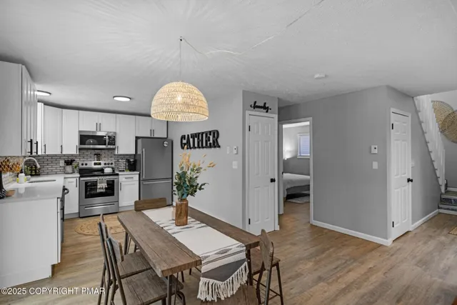 a kitchen with a table and chairs in it