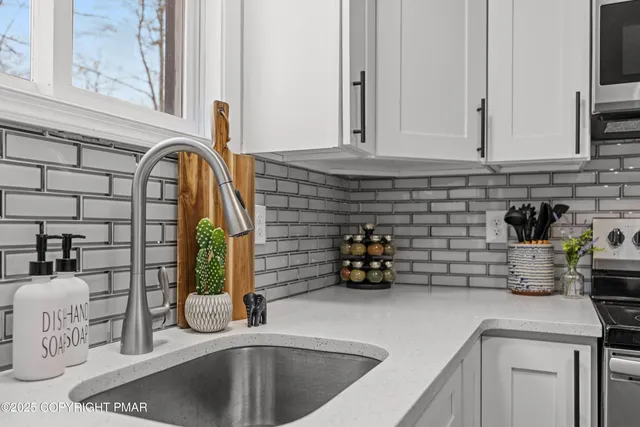 a kitchen with sink and cabinets