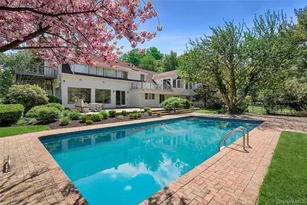 a view of a house with swimming pool and yard