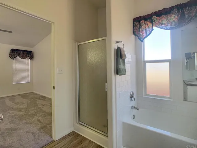 a bathroom with a tub and a shower