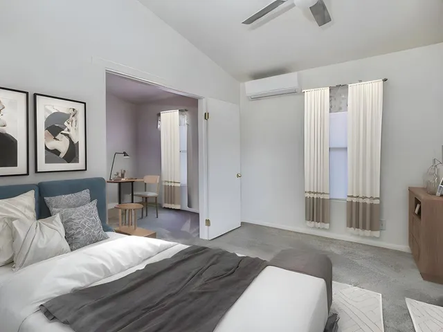 a living room with furniture and a painting on the wall