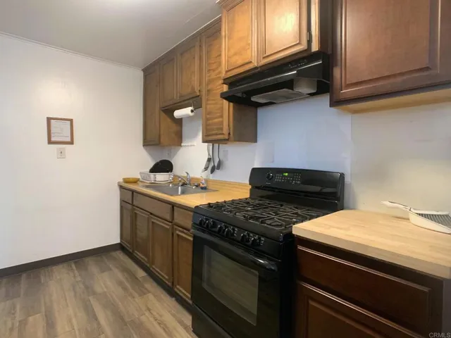 a kitchen with granite countertop a stove and a microwave