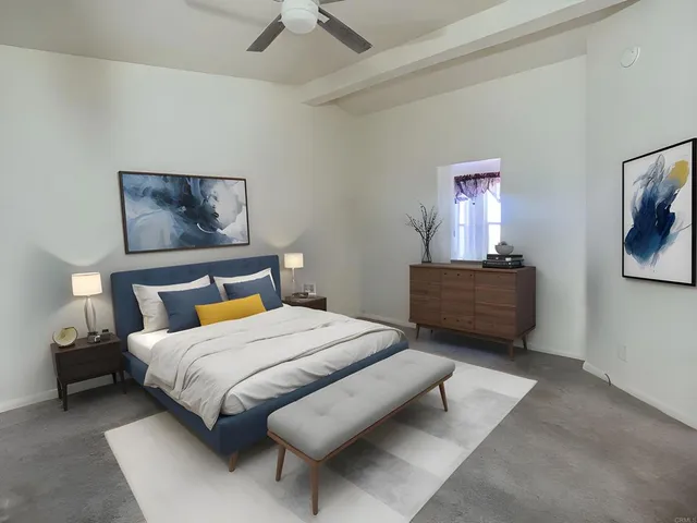 a bedroom with a bed and a painting on the wall